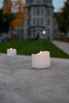 Following the recitation of the 270 names of the victims, the 2022-23 cohort of Remembrance Scholars places electric candles along the edge of the memorial’s wall. The memorial was dedicated in 1990.