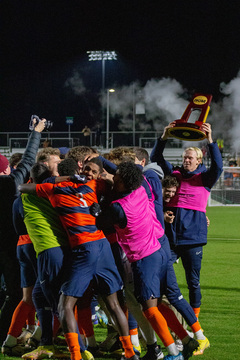 The team crowds around Sinclair to congratulate him on his game winning kick. Buster Sjoberg held the trophy for the first time and lifted it above his head so all could see.