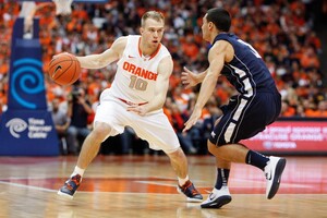 Syracuse guard Trevor Cooney dribbles past Monmouth's Max DiLeo in the Orange's 108-56 win over the Hawks on Saturday. Cooney hit five 3-pointers to finish the game with 15 points.