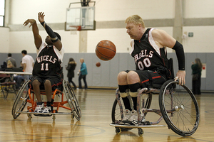 (From left) John Spinks and Tom Lawson, players on the Rochester Wheels, warm up before an exhibition game. The players participated in OrangeAbility 2013, featuring sports like power soccer and wheelchair basketball.