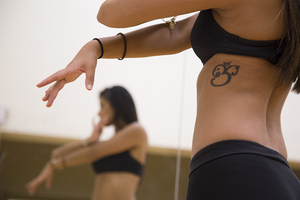 Kali Mehrotra, a senior writing and rhetoric and  English textual studies major, uses her Om sign tattoo to represent her dance style and Hindu culture.