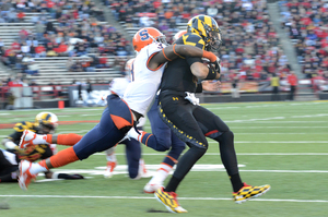 Durell Eskridge drags down C.J. Brown. The Syracuse safety also picked off the Maryland quarterback before leaving the game with an upper-body injury.