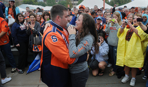 Ryan Giarrusso and Katie Lappin embrace after Giarusso proposed to Lappin on the quad before the SU - Clemson game Oct. 5, 2013.  Giarrusso diguised himself as a member of the SU Marching Band, rushing up to her after the band performed a song on the steps of Hendricks Chapel.  The band was playing at a pep rally before the game.