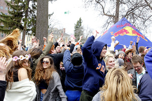 Students jump up and down while taking in music at Walnut Park. 