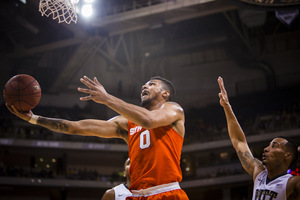 Syracuse point guard Michael Gbinije blows past a Pittsburgh defender and attempts a layup. Gbinije and the Orange are still looking for their first conference win this season.  