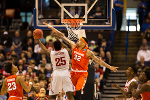 Dajuan Coleman challenges a shot by Dayton's Kendall Pollard. Coleman and SU pounded the Flyers in the first 10 minutes of the second half.  