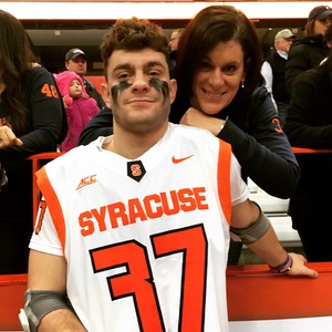 Jakob Phaup and his mother, Beth, pose after a game in the Carrier Dome. 