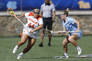 Emma Ward attempts to round the crease while marked by UNC's Livi Lawton. Ward notched two goals but it wasn't enough as Syracuse lost to North Carolina