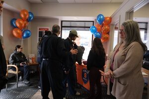 Community members and DPS staff gather near the reception desk of DPS' new substation on Marshall Street. The office, located at 737 S. Crouse Ave., is now open and operational.