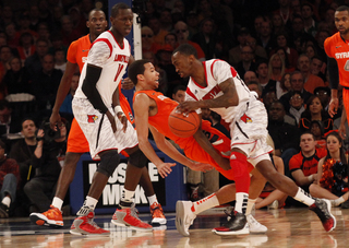 Louisville's Russ Smith (#2) knocks over Michael Carter-Williams while defending.