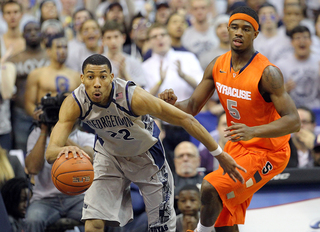 Otto Porter pushes the ball down the court as C.J. Fair watches on.