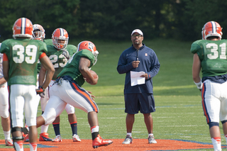 Running backs coach DeAndre Smith instructs his group of ballcarriers.