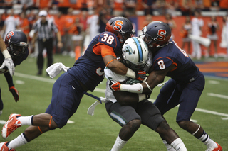 Linebacker Cameron Lynch and cornerback Keon Lyn combine for a tackle against Tulane.