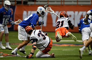 Ben Williams (37) and Messina scrap for a faceoff as Messina flies through the air.