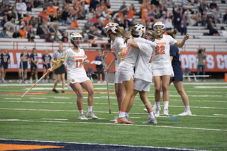 Syracuse players hug after a goal. 