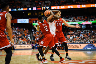 Bourama Sidibe is stripped of the ball by two NCSU defenders. 