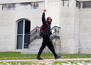 A student raises his fist in support of the students protesting over the Theta Tau video. 