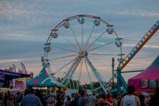 Fairgoers ride one of two Ferris wheels featured at the New York State Fair. 