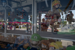 Fairgoers play games with the hopes of winning prizes.