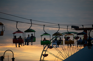 Fairgoers ride the ski lift across the grounds at the New York State Fair. 