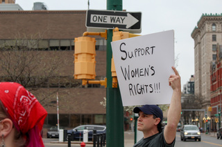 Members of the Syracuse community join the crowd to show their support for women’s rights. 
