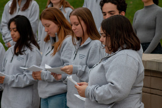 Remembrance Scholar Mira Berenbaum reads the names of some of the 270 Pan Am Flight 103 victims at the candlelight vigil. Several of the scholars took turns reading as they stood in front of the Remembrance Wall. 