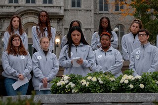 Remembrance Scholar Diane Benites reads the names of several Pan Am Flight 103 victims aloud to the silent crowd. Benites, who represents Eric Coker, said during the event that the discovery of the twins’ letters should push the SU community to act against hate.