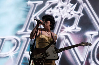 King Princess opens for Red Hot Chili Peppers along with The Strokes. Her dress and pastel background was a sharp contrast to the other two rock bands. 